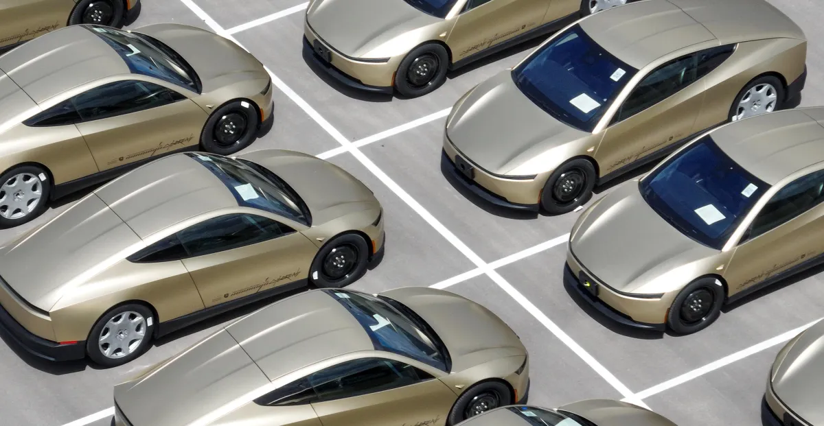 An autonomous vehicle driving through a busy urban intersection.